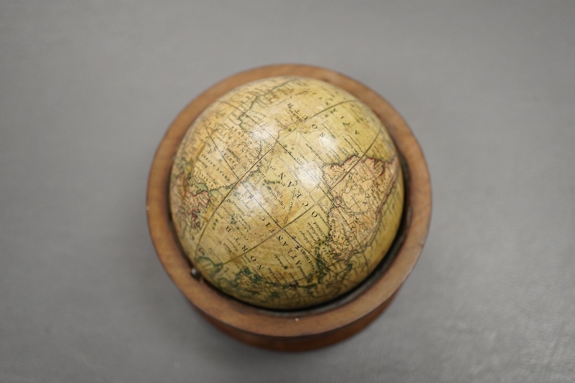A Newton’s New and Improved Terres[trial] Glo[be], (pocket globe), 3inch diameter, rotating in a 3.3/4 inch later turned mahogany stand, plotting Cook’s voyage of the 1770’s, restored, as specified by Baynes-Cope, but wi